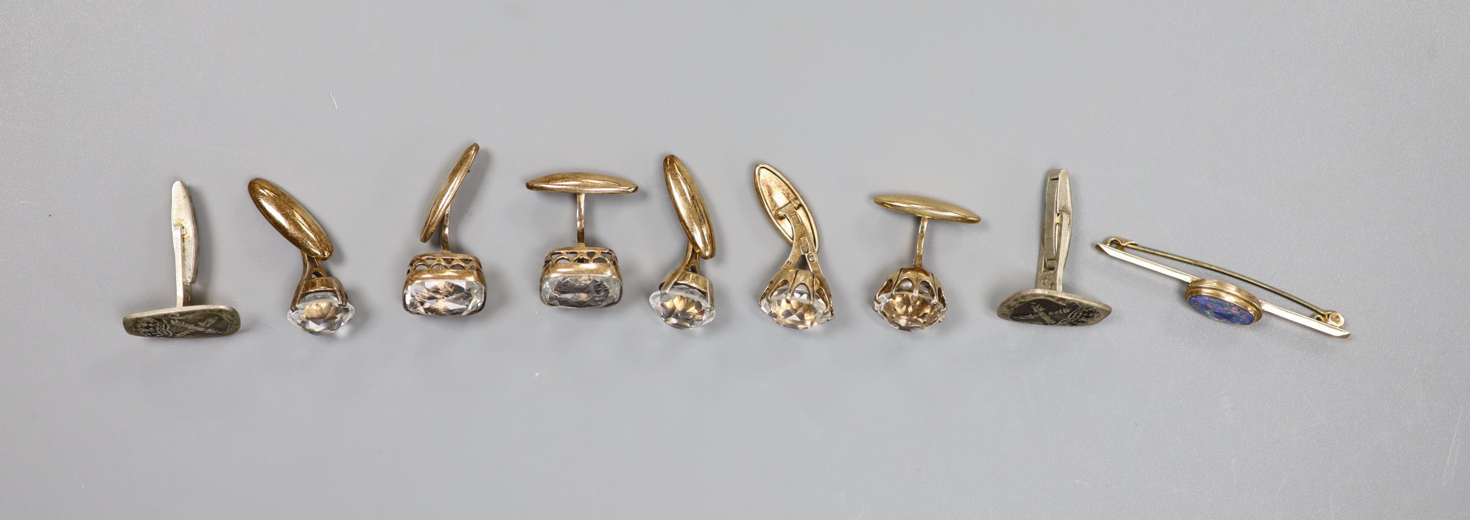 Three assorted pairs of continental gilt white metal and rock crystal set cufflinks, one other pair, a 9ct and black opal doublet set bar brooch and an unmounted synthetic ruby.